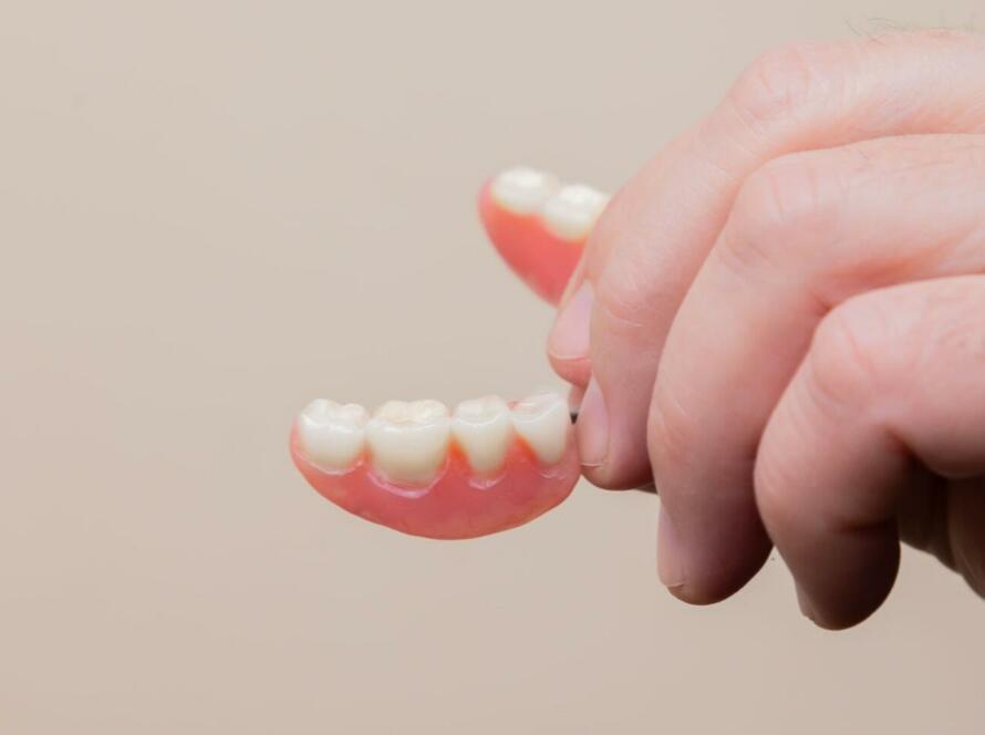 person holding pink plastic hair clip