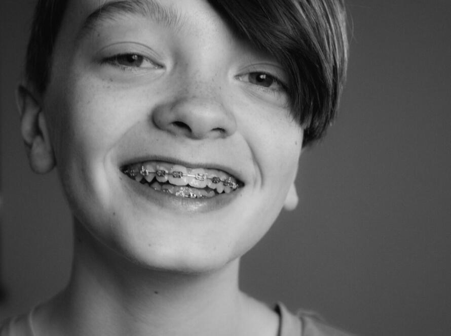 grayscale photo of smiling girl