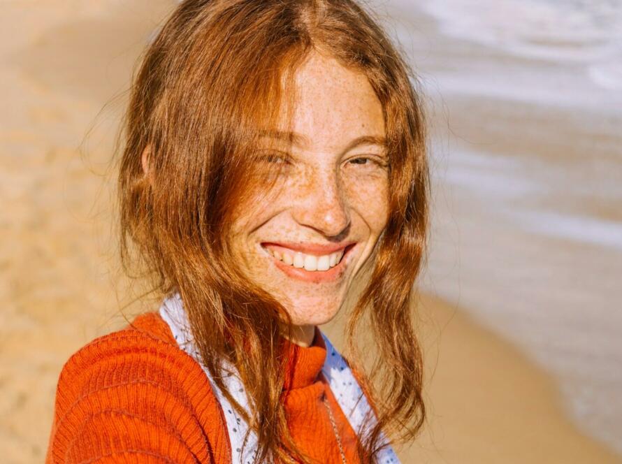 woman in red knit sweater smiling